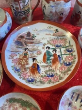 10pc. Geisha Girl Red Trimmed Porcelain. Saucer, Plate, Demitasse cups, Japan.