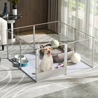 52-inch clear acrylic indoor dog playpen with eight panels, gray cushioned floor mat, and assorted dog toys.