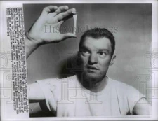 1959 Press Photo Norman Hickey holds an instrument that prevented sudden death