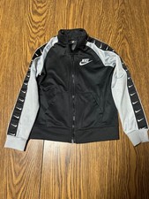 Nike boys' full-zip track jacket in black and grey featuring logo tape along the