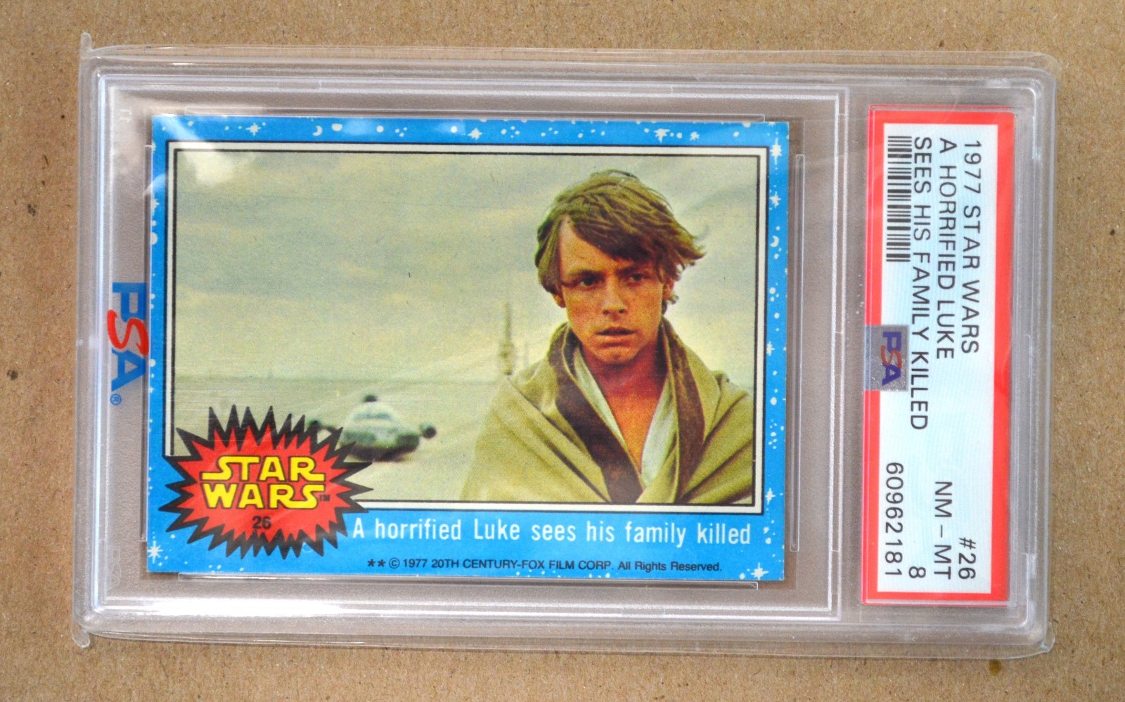 1977 Topps Star Wars #26 A horrified Luke sees his family killed  PSA 8  POP 98