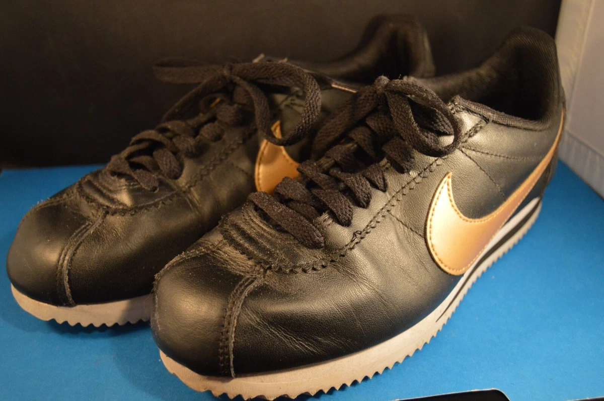 Womens black nike with shop gold swoosh