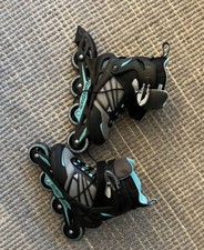 roller blades, womens size 8, black with blue wheels, used once, great condition