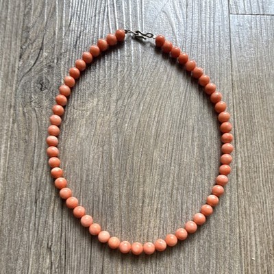 Peach Coral 7mm beads with silver clasp.