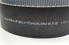 Black GATES 14MGT-994-90 Poly Chain Belt with green printed specifications and “Made in U.S.A.” text on black surface.