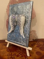 Handmade Angel Wings Wall Decor on a wood block.