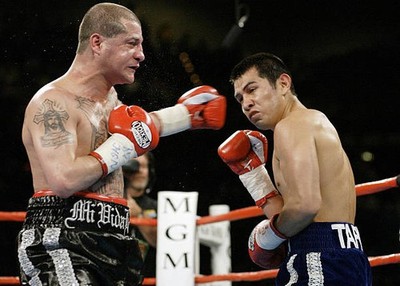 Marco Antonio Barrera is hit by Johnny Tapia during their middlewe- Old Photo 1