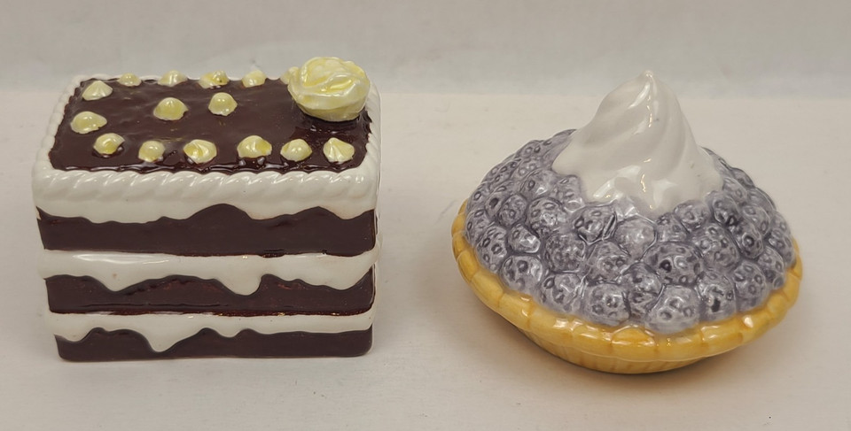 Kitschy 90s ceramic salt & pepper shakers shaped like a chocolate cake and berry pie — a delightfully weird desk or kitchen conversation piece.