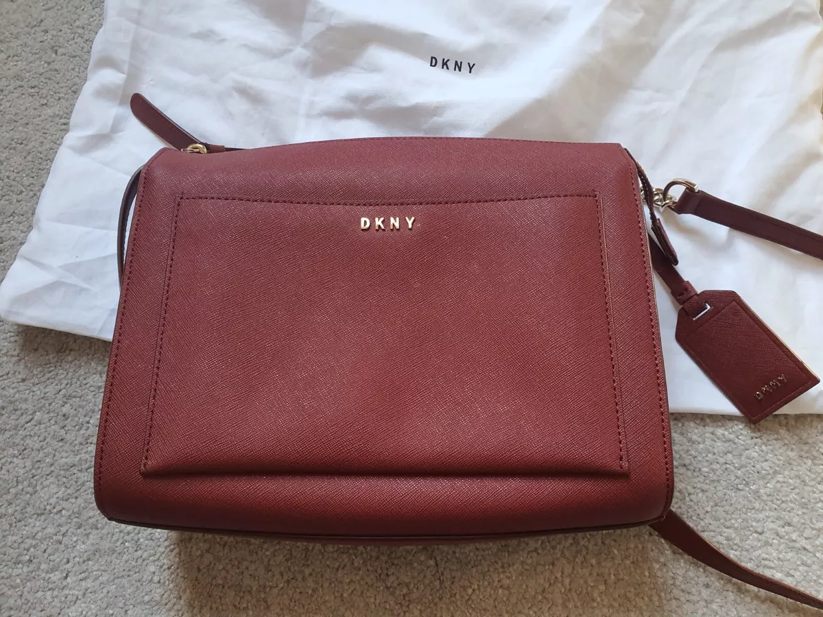 DKNY red leatherhandbag. Crossbody. Adjustable straps. Designer handbag