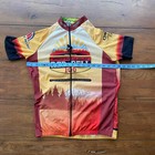 Yellow, red, and black JLvelo men’s cycling jersey with “WORLD BIKE RELIEF” text, sun graphic, and Cascade Bicycle Club event logo.