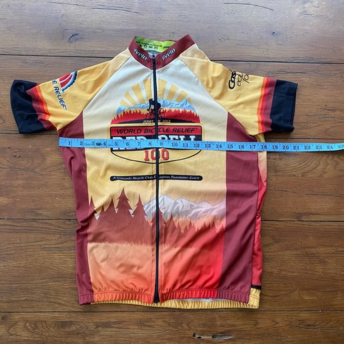 Yellow, red, and black JLvelo men’s cycling jersey with “WORLD BIKE RELIEF” text, sun graphic, and Cascade Bicycle Club event logo.