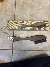 This is a vintage wooden hanger-brush set designed for clothing care.