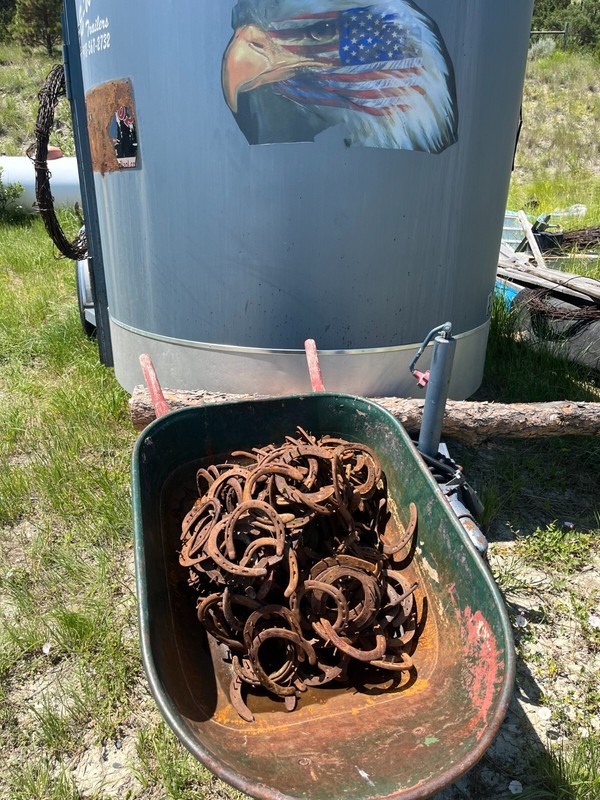 Box of 21 Used Horseshoes & 21 ft. of old barb wire shipped together.