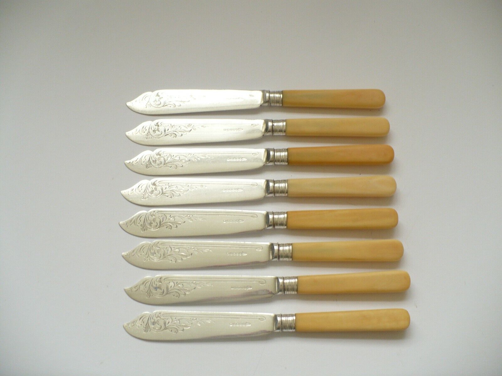 8 X VINTAGE SILVER PLATED FISH KNIVES WITH ENDRAVED DECORATION - WALKER & HALL -