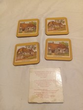 Set of four vintage drinks coasters featuring traditional English cottage illust