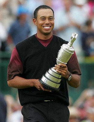 Tiger Woods of the USA hugs the Claret Jug after securing a five s- Old Photo