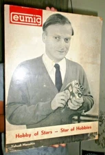 Eumig Vintage Projectors advertising sign cardboard depicting man with camera "