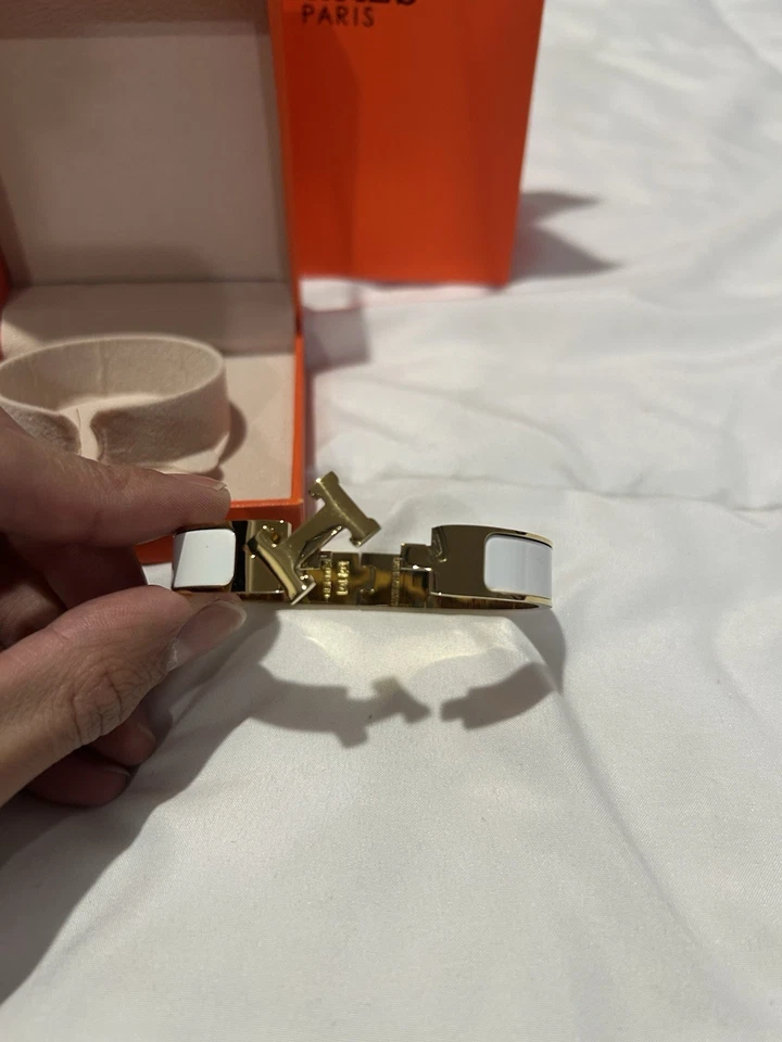 Brazalete brazalete Hermes Clic H dorado y blanco para mujer Foto 2 de 4