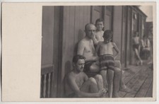 Original vintage 1940s people in swimwear by beach cabins