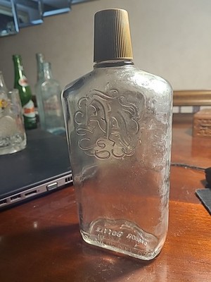 Vintage Bourbon Whiskey Bottle A A On Front And Wreath One The Back. Shot Lid.