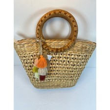 Handcrafted Woven Straw Tote Bag with Round Wood Handles and Tassel Charm
