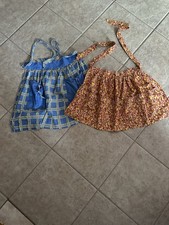 Two vintage handmade cotton aprons with plaid and floral patterns.