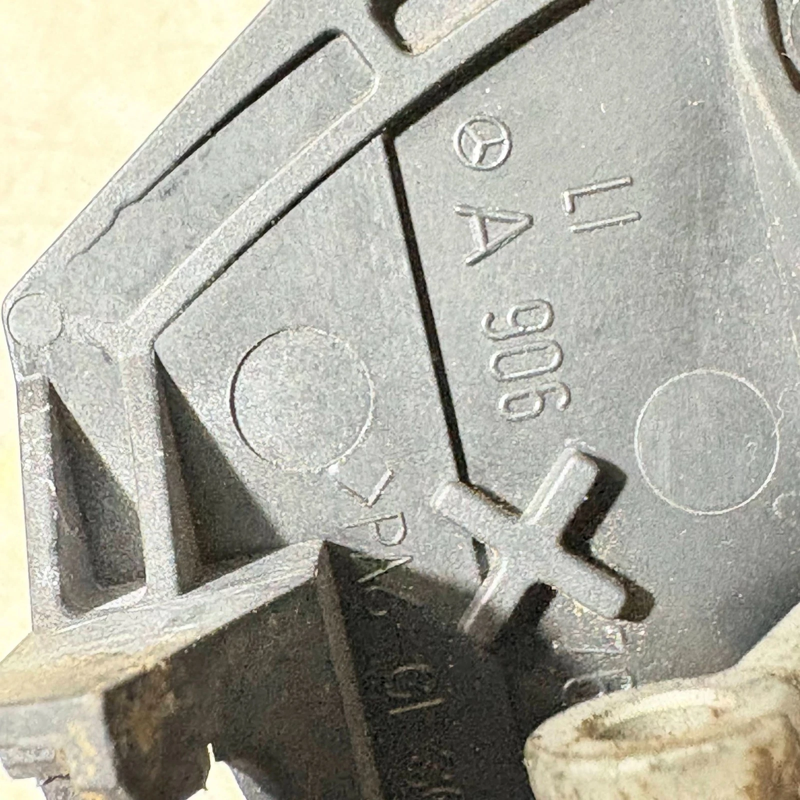 Close-up A 906 and left LI marking on Mercedes door handle carrier