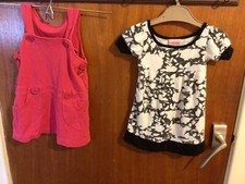 For 9-12 months baby: 2 Dresses:  Cherokee: black/ white & Pink. Machine wash.