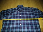 Navy, red, and blue plaid Burberry London shirt size L with white buttons, made in USA on yellow measuring tape.