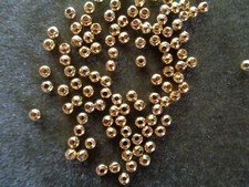 Gold-plated brass bead, 4mm round. Sold per pkg of 100.