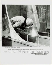 Press Photo Workman welds metal hull of ship at shipyard in Japan - lrb44293