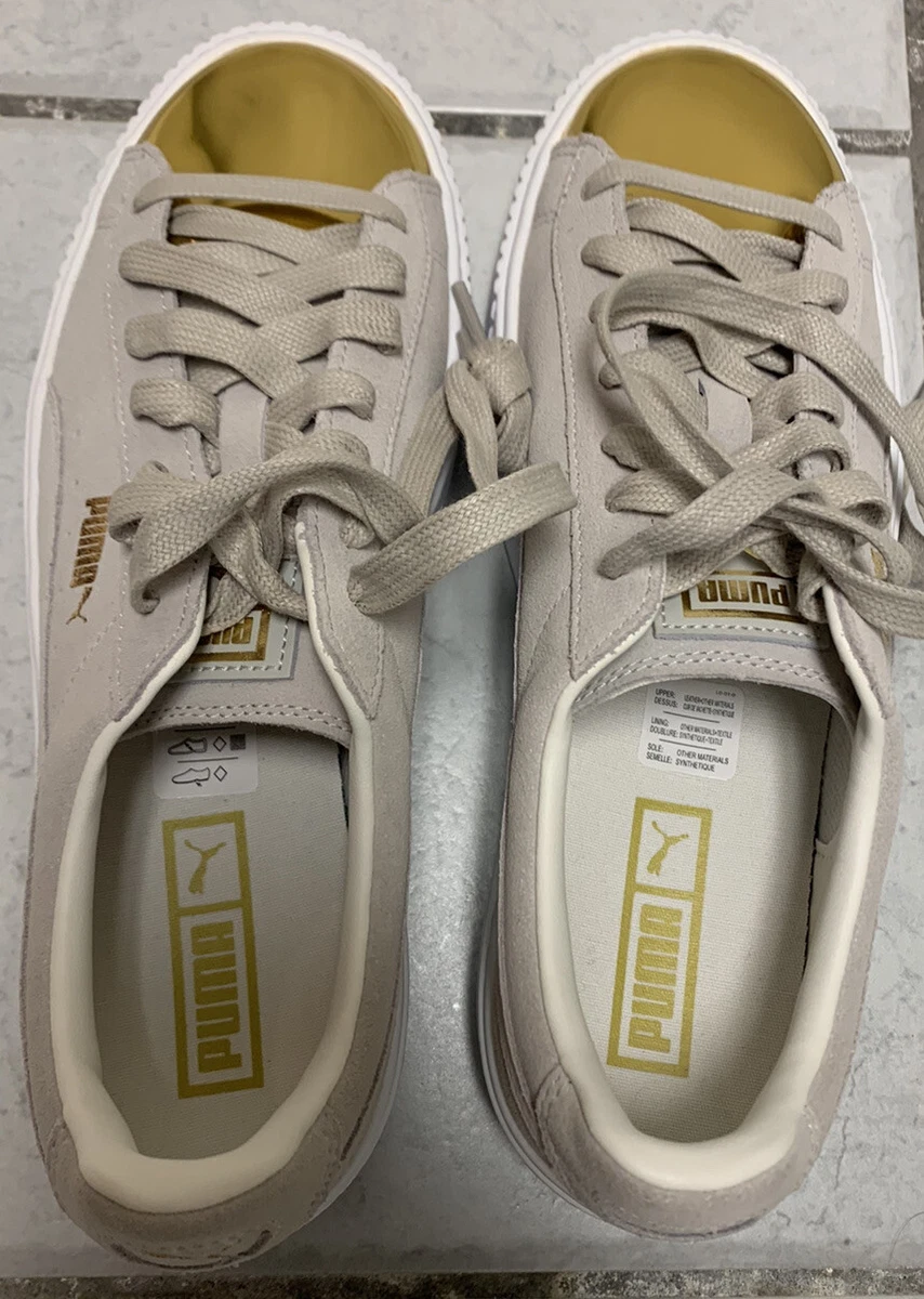 White pumas with gold clearance tip
