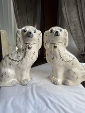 A pair of antique Victorian Staffordshire spaniel mantel dogs (circa 1890–1920).