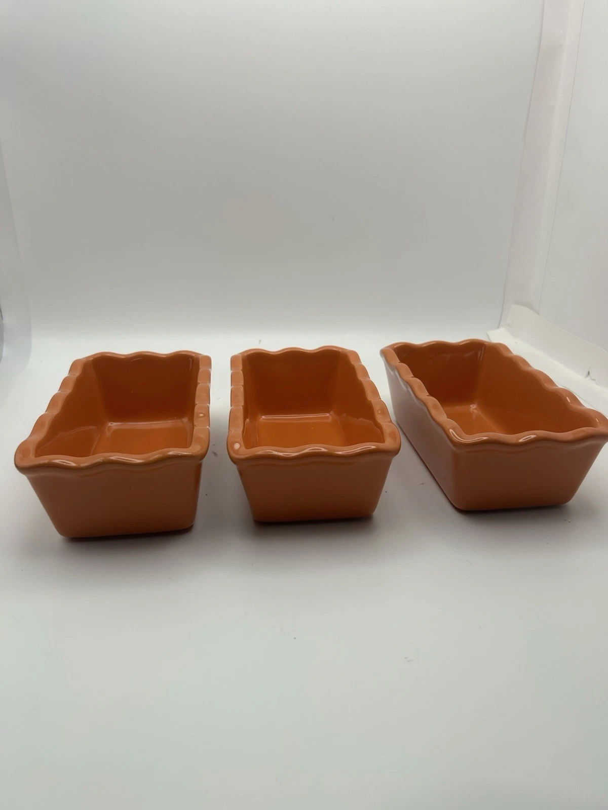 3 Stoneware Loaf Pans With Scalloped Edges.