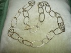 HAND MADE NECKLACE OF GOLDTONE ELONGATED HAMMERED LOOPS, OPERA LENGTH