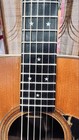 Black Martin D-76 with silver stars on f-holes, gold hardware, and dark wood fretboard with white inlay.