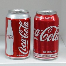 2. Lata de Coca Cola vacía 355 ml.   Juego de 2 piezas
