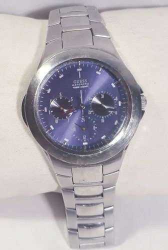 silver guess watch with blue face