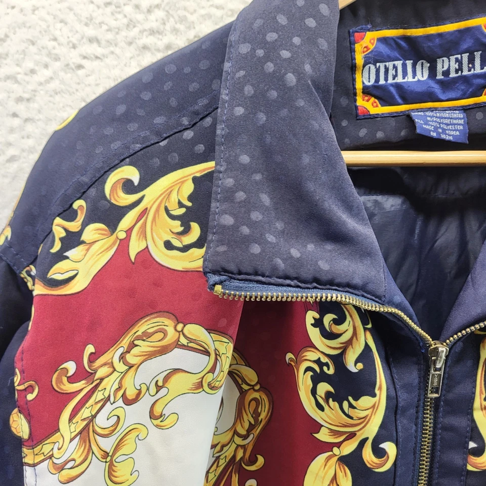 Chaqueta cortavientos Otello Pelle para mujer azul medio cadenas AOP dorada de gran tamaño Foto 2 de 4