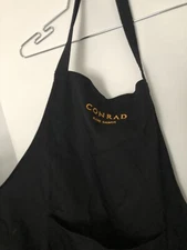 Black Apron  Conrad Logo