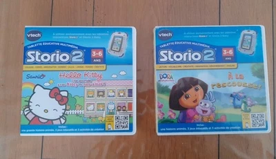 LOT 2 JEUX HELLO KITTY DORA - Jeu STORIO 2 VTECH complet VF FONCTIONNELLE - Photo 1/4