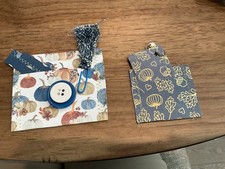 Two Hand made junk journal pockets. with tags, paper clips.