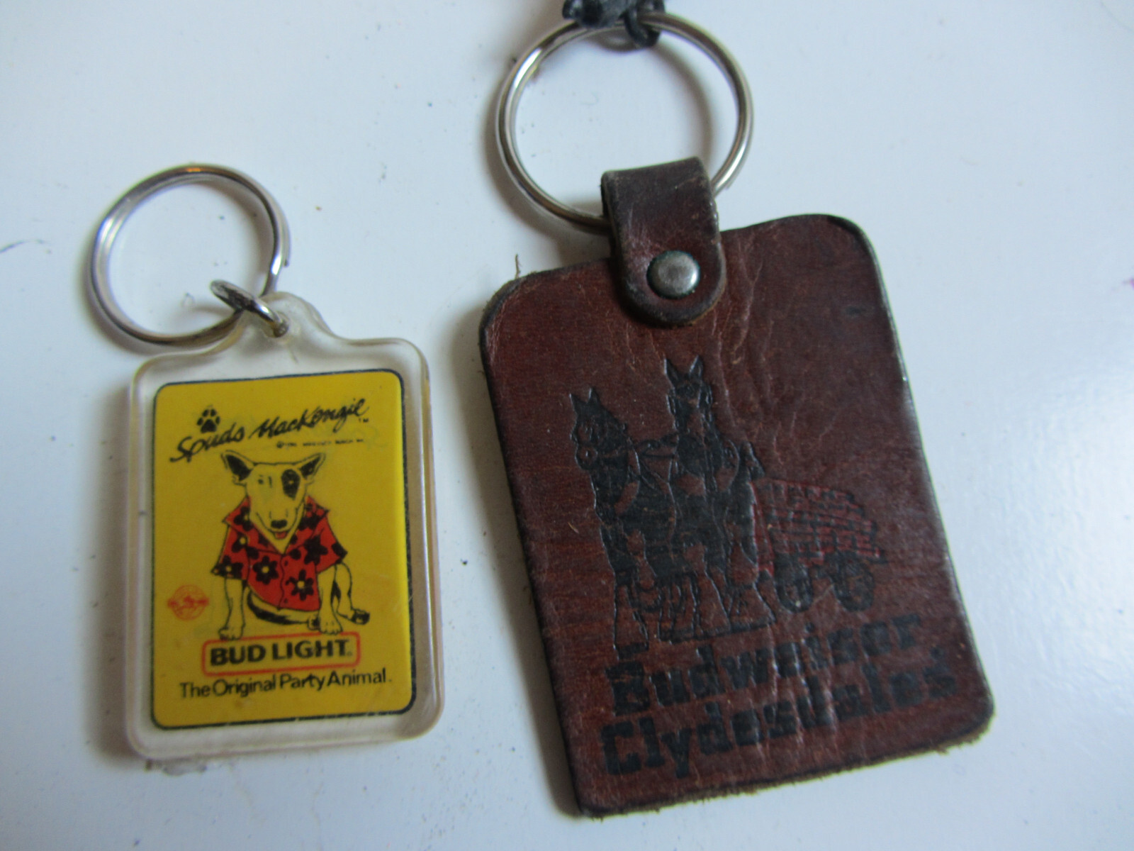 2 VINTAGE 1980'S BUDWEISER ADVERTISING KEYCHAINS SPUDS MACKENZIE & CLYDESDALES