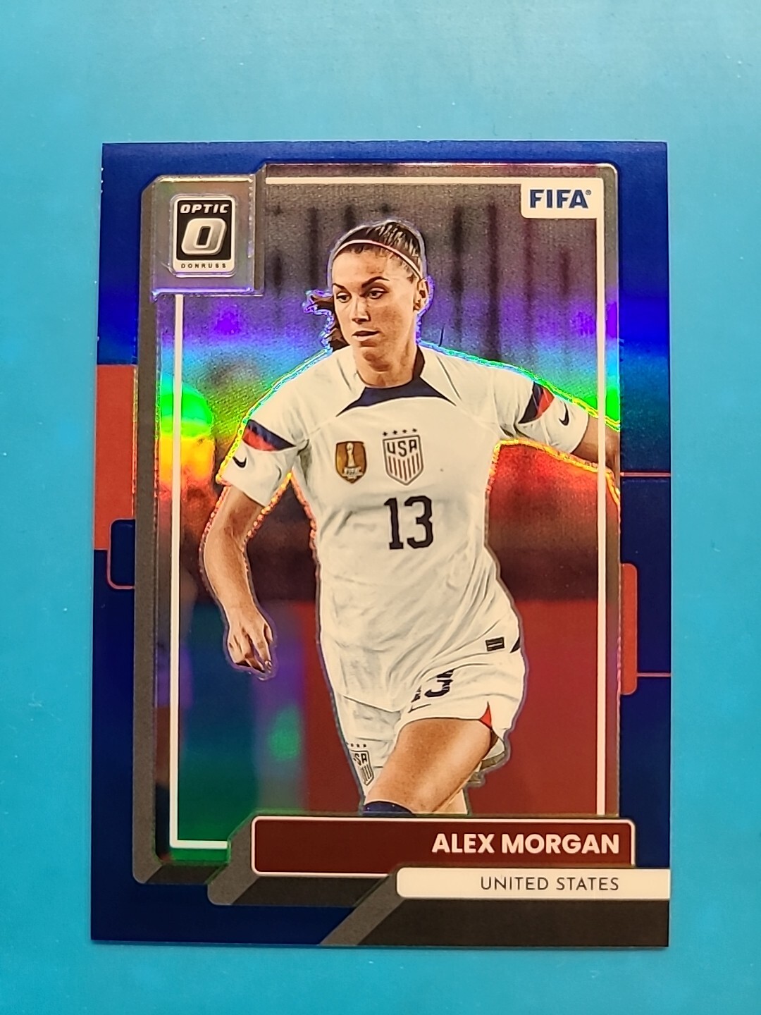 2022-23 Donruss Optic FIFA Alex Morgan #124 Blue Prizm /99 USWNT United States