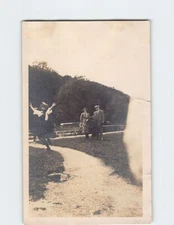 Postcard Photograph of Three People Standing Near a Fence Outdoors
