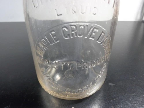 VTG. MAPLE GROVE DAIRY SUGAR CREEK, OHIO. ONE 1 QUART EMBOSSED GLASS MILK BOTTLE