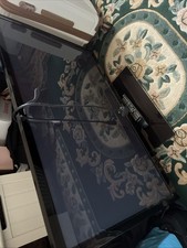 Samsung Tv With Glass Stand Along With Remote Controller