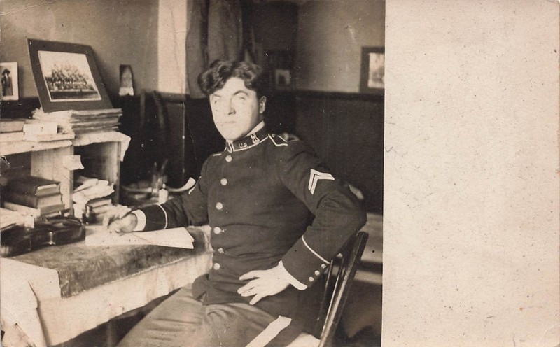 RPPC YOUNG US ARMY SOLDIER SEATED AT DESK c1910 REAL PHOTO POSTCARD 070626 V