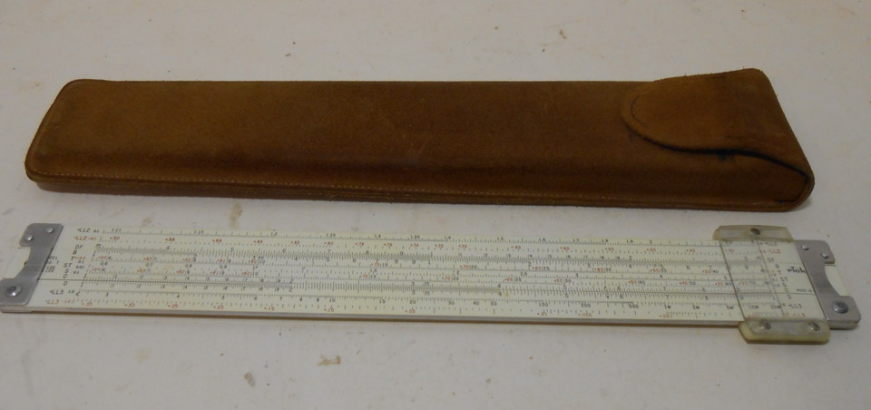 A 1962 all-metal Pickett Hi Log/Log slide rule with leather case — striking silver finish sets it apart from bamboo competitors and it's a genuine Space Age artifact.