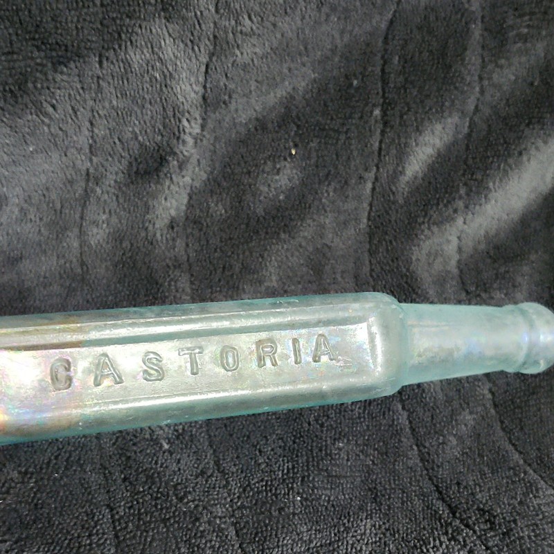 CASTORIA Embossed Clear Glass Medicine Bottle w/ Iridescent Finish